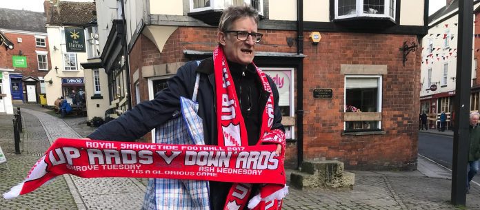 A man selling scarves in Ashbourne on the two days of Shrovetide. Photo: John Grant