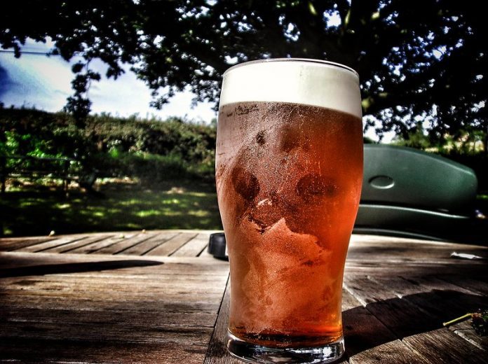 A pint of beer on an outdoor table