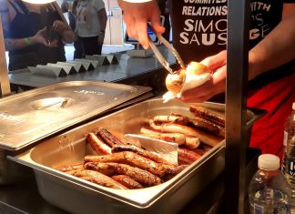 This is an image which shows sausages being cooked