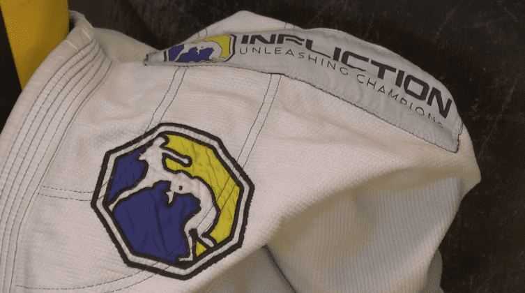 A close-up of a logo on a white judo robe