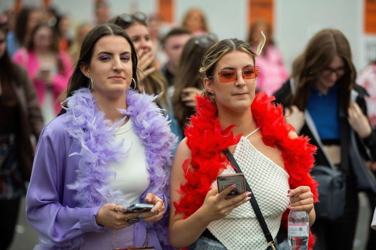 This is an image of Harry Styles fans wearing feather boas. 