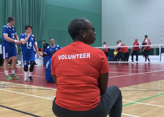 Pictured is a volunteer court steward at a sitting volleyball event.
