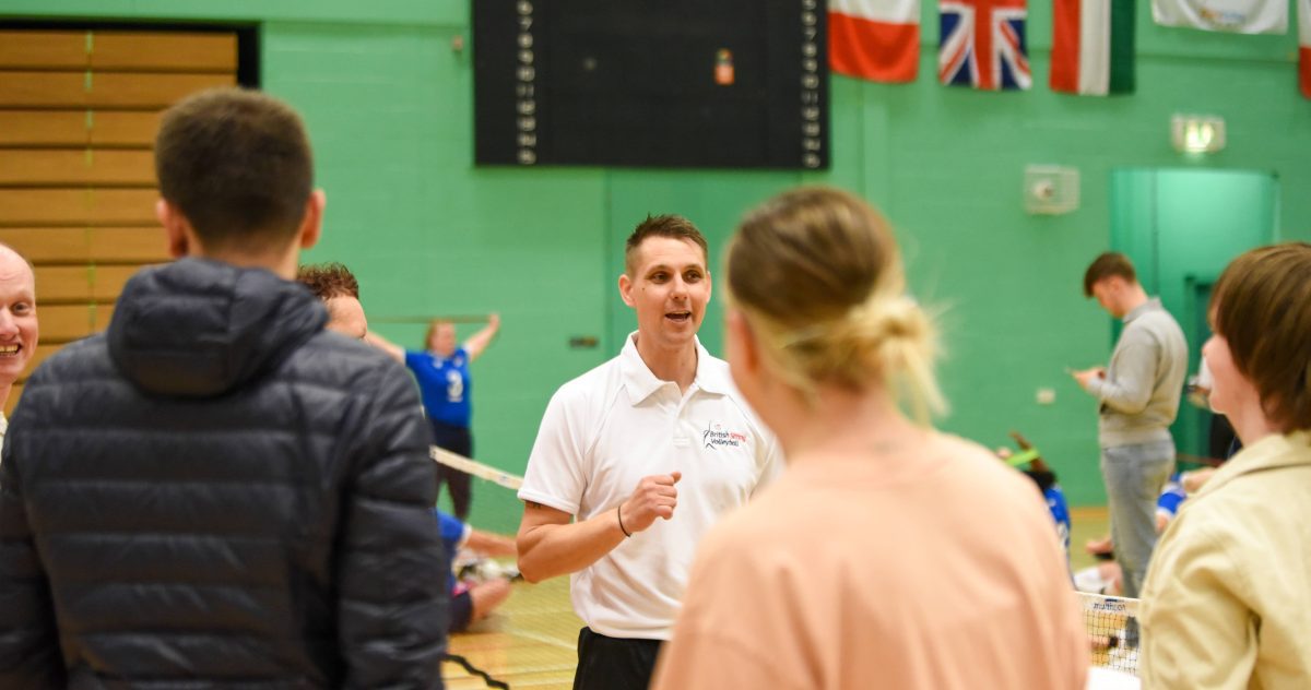 UK Sport volunteer speaking to members of the public at Sitting Volleyball tournament