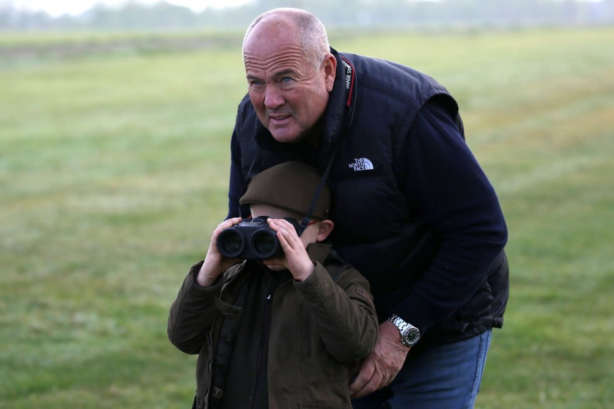 Tony with his grandson watching horses on the gallops