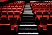 Photo of the inside of a cinema displaying the rows of seats.