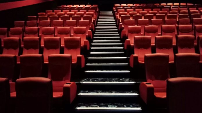 Photo of the inside of a cinema displaying the rows of seats.