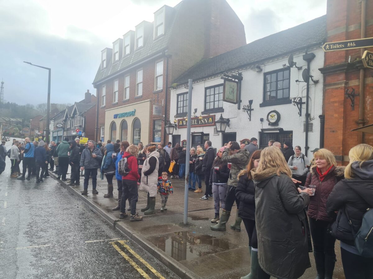 An image which shows the crowd outside the Wheel Inn, in Ashbourne
