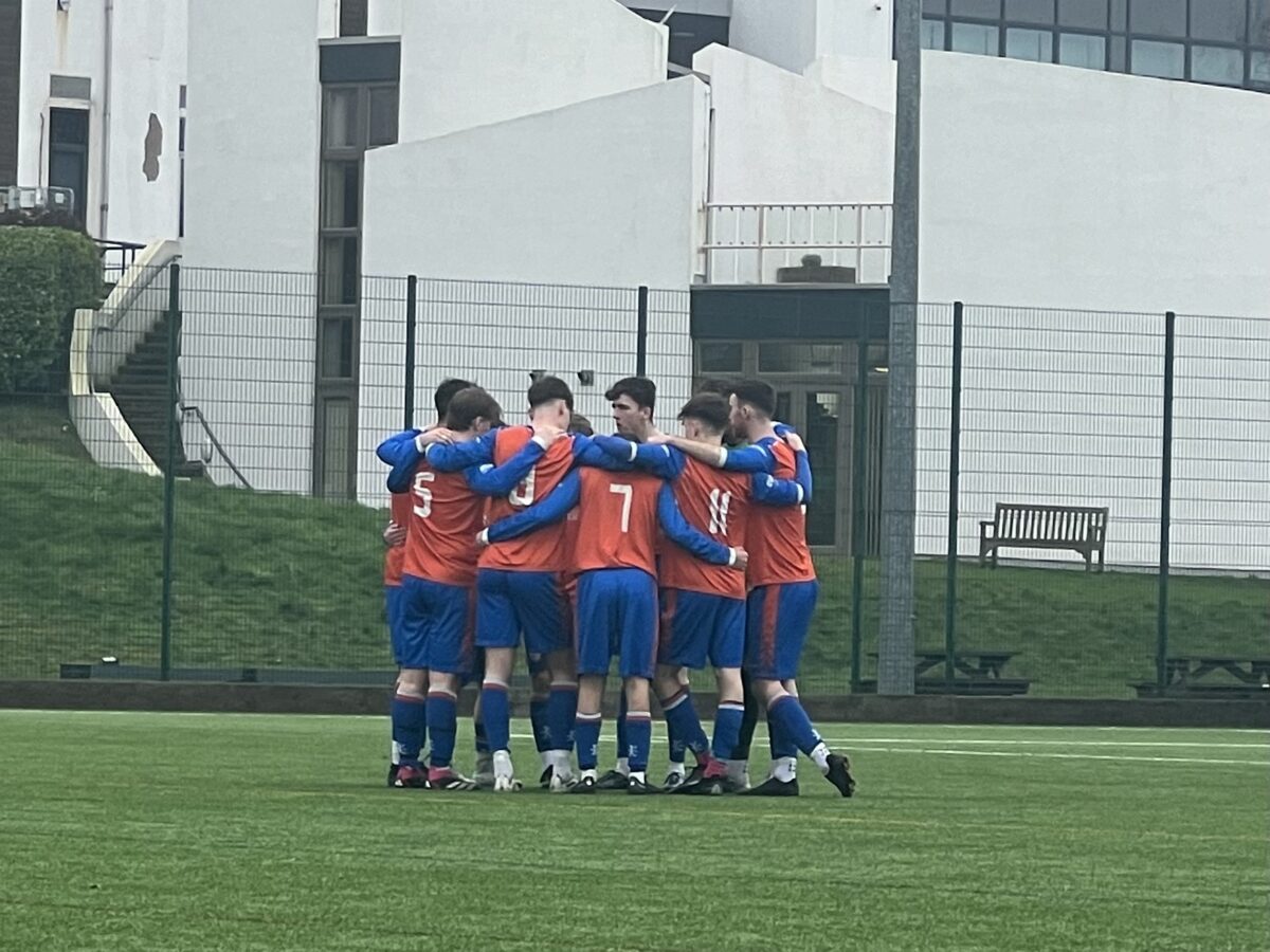 This image shows Derby men's 3rds in a huddle before their game vs Derby 4ths