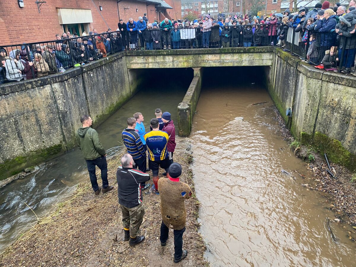 Pictured are people near the culvert in Ashbourne for Shrovetide
