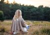 Woman in the field meditating