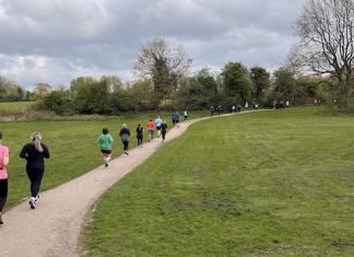 This is a picture of runners jogging around the 5K parkrun circuit in Markeaton Park.