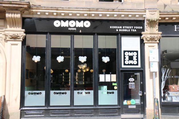 View of OMOMO restaurant from the street while it is open.