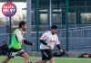 An image depicting two people playing football at the University of Derby with the Faith and Belief Month logo and 'Spirit in Sport.'