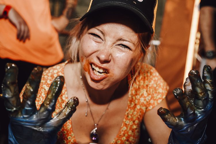 Woman has dirty fingers and mouth attending one of the eating competitions.