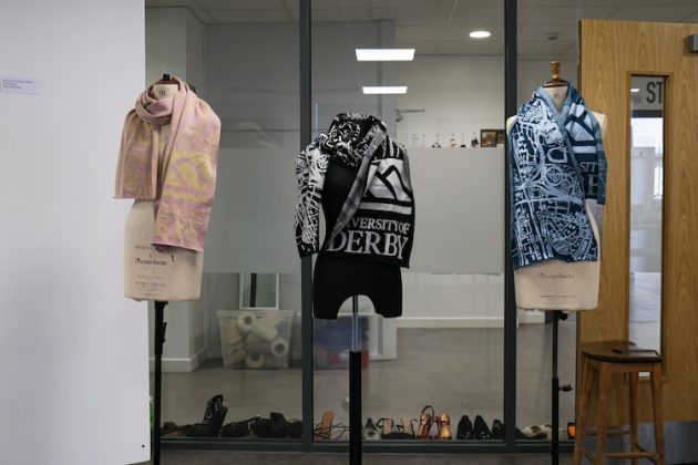 Three mannequins with University of Derby inspired outfits on them.