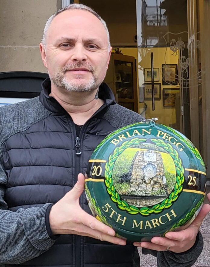 This image shows Tim Baker with the ball he designed for Shrovetide 2025