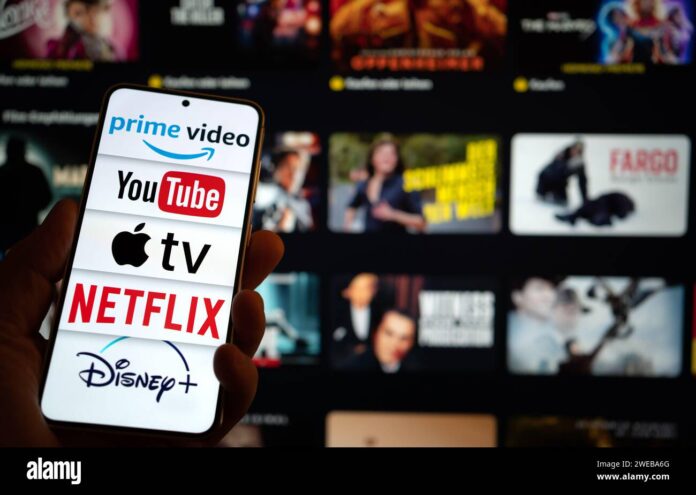 Streaming platforms on a phone with TV in background