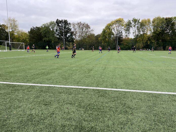 Derby 2s (orange and blue) in action at Kedleston Road.