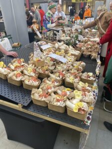 This image shows Derbyshire Mushrooms stand at the Derby Farmer Market on the 22nd of February 2026. There are customers purchasing mushrooms from the stand.