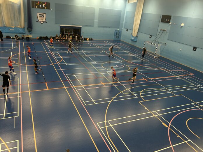 Derby futsal women's firsts (orange and blue) in action against Nottingham Trent women's futsal firsts (green and gold) at Kedleston Road in Derby's 3-2 victory over Nottingham Trent on Wednesday, February 11, 2026.
