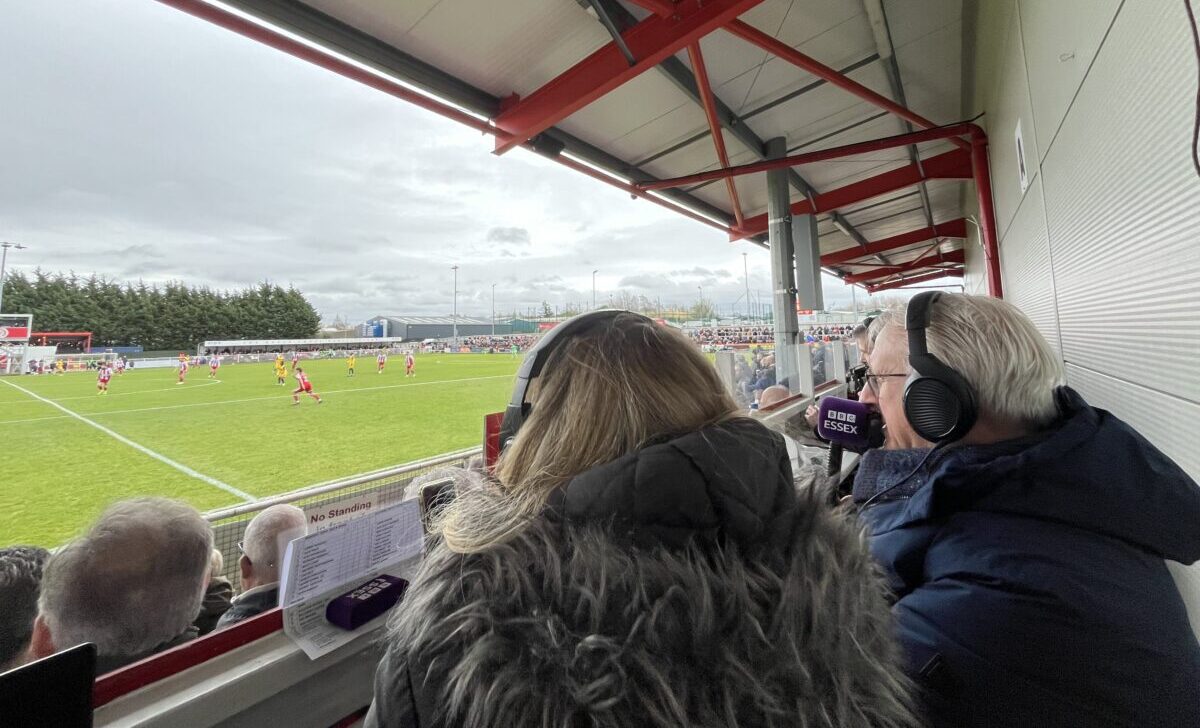 Image of Glenn Pennyfather commentating from the press box at Brackley Town.