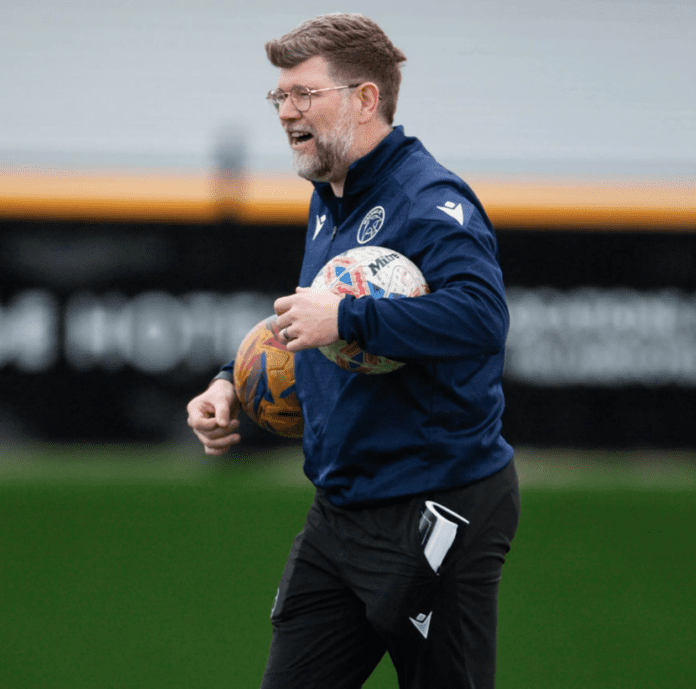 This image shows Matt Willis, Walsall Women Head Coach, holding two footballs during Walsall's pre-match warm up as they geared up to play Lye Town Women in the Women's FA Cup in October 2025.