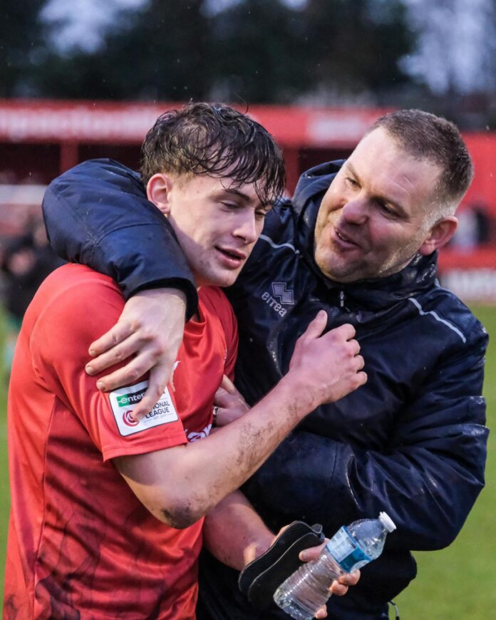 Jake Buxton celebrating with Luke Alker after his debut vs Merthyr