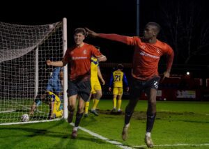 Jo Cummings and Josh Ayres running off to celebrate in front of the home fans after scoring a goal for Alfreton